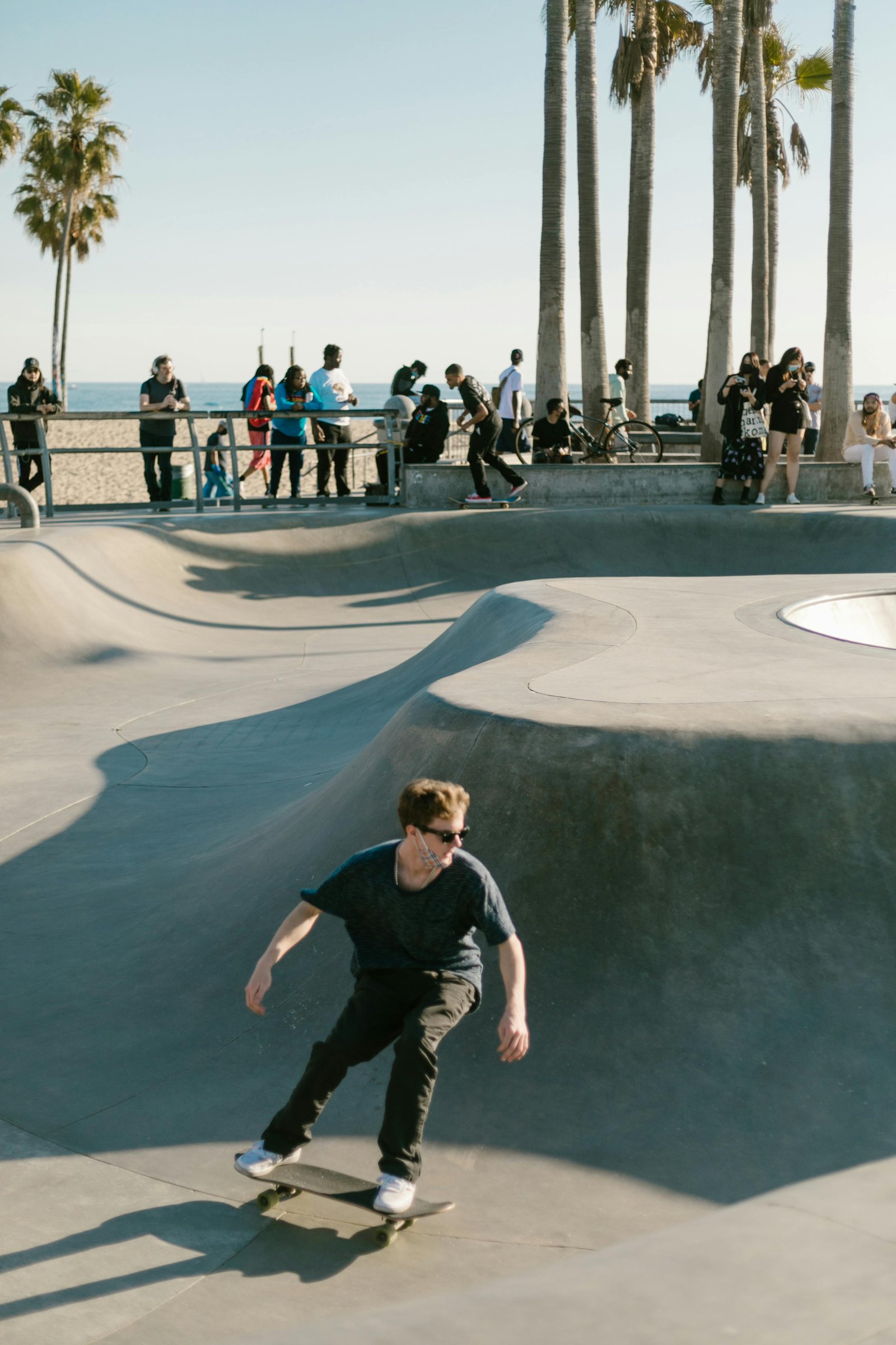 Skater clearing a stair set in an open concrete park